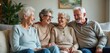 © Vadym - Group of four elderly people, smiling and laughing together. Diverse group enjoys time in cozy living room setting. Happy senior friends sitting on couch, laughing together, enjoying retirement.