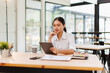 © David - Young asian business woman manager accounting analyst checking bills, analyzing sales statistics management, taxes financial data documents or marketing report papers working in office using laptop.