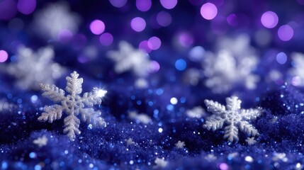 Wall Mural - Glittering snowflakes on a vibrant blue and purple bokeh background create a festive and magical winter scene.