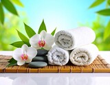 Tło spa z białymi kwiatami, okrągłymi kamieniami i zwiniętymi ręcznikami. Baner salonu piękności. Masaż, wellness, odpoczynek, piękno
