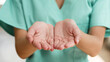 © Meeko Media - Close-Up of Open Hands in Medical Uniform Suggesting Caring and Compassion