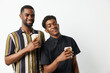 © SHOTPRIME STUDIO - Two black men enjoying coffee together, smiling brightly in casual clothing. Capturing friendship and joy in a relaxed setting, ideal for lifestyle themes.