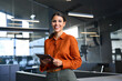 © Stock 4 You - Executive CEO businesswoman saleswoman holding digital tablet pc device for work in office, looking at camera. Smiling successful latin hispanic young woman using pad tab computer for business app