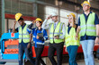 © 2B - Group of construction workers conducting safety inspection in industrial facility during daylight