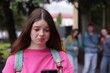 © New Africa - Teenage girl with smartphone suffering from bullying at school, selective focus