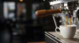 Close up of espresso machine dispensing fresh, steaming coffee into a white cup. The rich, aromatic liquid fills the cup with inviting warmth