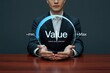 © Kazi - Businessman holding a glowing circle with the word value and unlock your potential text inside