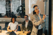 © Maskot - Businesswoman explaining strategies to team over television screen in meeting