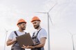 © anatoliycherkas - Engineers working on a laptop in a wind turbine power plant