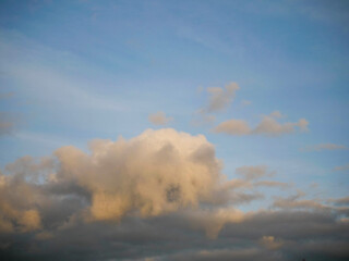Wall Mural - Amazing cloudy sky with cloud in a shape of an animal with ears, eyes and mouth and paws. Abstract background for design. Unusual nature shape and form.