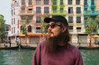 © Studio KME/Stocksy - Bearded Man by Venice-Inspired Canal