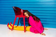 © Sergey Narevskih/Stocksy - Fashionable Woman Resting Head on Red Chair
