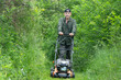 © Zoran Milich/Stocksy - Cutting tall Grass with a lawnmower