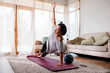 © Jovo Jovanovic/Stocksy - Woman doing side plank yoga pose at home.