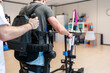 © Alvaro Lavin/Stocksy - Doctor assisting patient using robotic rehabilitation device