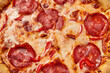 © Yaroslav Danylchenko/Stocksy - Close up of full pepperoni pizza with melted cheese closeup
