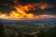 © efiederphoto - Expansive view of the Boulder, Colorado city skyline at dusk, overlooking the entire city with the Flatirons and Rocky Mountains in the background under a colorful twilight sky.