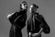 © María Soledad Kubat/Stocksy - Fashion editorial with two women in bold outfits, black and white pic