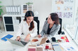 © Pichsakul - Asian Interior Designers Collaboration on Laptop for Home Renovation Project Adult Women Architects Discussing Color Material Palette for Interior Design and Decor in Office