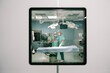 © Santi Nuñez/Stocksy - Surgeons using digital tablet during surgery in operating room