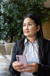 © Ranta Images - Asian businesswoman in cafe restaurant using digital tablet computer