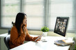 © Prathankarnpap - Asian woman participating in a virtual team meeting from her home