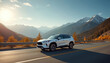 © Pete - White SUV drives on highway mountain landscape. Vehicle road trip adventure in fall autumn season. Travel by automobile, experience freedom with car outdoors.