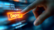 © Pukan - A finger is pressing a glowing 'Deploy' button on a digital interface, symbolizing software deployment or launching a tech project.