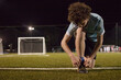 © Austockphoto - Young teen boy preparing to do evening soccer training