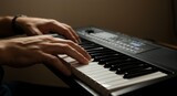 Skilled hands gracefully play a musical keyboard, illuminated by soft light in a dimly lit room, creating a serene and artistic atmosphere.