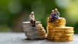 © Yuliia - Senior couple sitting on stacks of gold and silver coins, representing retirement savings, pension funds and financial planning for elderly people.
