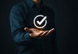 © Image stock - Man holding a glowing checkmark symbol representing success and approval