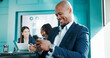 © peopleimages.com - Smile, business and man with phone in office for financial report, reading email and proposal. Happy, male person and mobile in meeting for schedule, budget update and feedback on investment funding