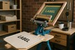 © Татьяна Евдокимова - Screen printing machine printing a custom label on a tote bag in a workshop, small business and serigraphy concept