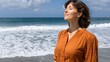 © PaulShlykov - Woman enjoying the seaside with her eyes closed and a peaceful expression on her face