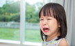 © paulaphoto - Portrait of little asian crying girl little rolling tears drop cheek weeping emotion hurt pain. Young asian toddler girl in terrible two. Back to school education concept