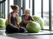 © TWIN - A young physical therapist assists an older woman with exercises using a large green exercise ball in a bright studio