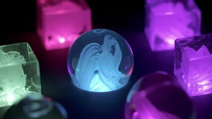 Abstract shapes frozen in clear cubes and spheres, colorful