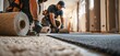 © rangga - Professional flooring installers laying new carpets in a residential construction site