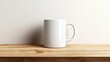 © kachanovski - a white coffee mug sitting on a wooden table