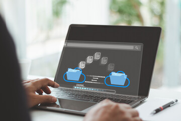 Cloud data transfer and file sharing, digital folder backup and document migration system. Hand using laptop to transfer data files between cloud storage folders, online digital document management.