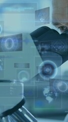 Wall Mural - Animation of scopes scanning and data processing on screens over male scientist using microscope