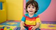 © Bhagya - Happy caucasian toddler boy in a colorful shirt sitting on the floor, engaged in creative play with building blocks at a vibrant daycare or kindergarten.
