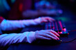 © pressmaster - Hands of teenage girl gamers using computer keyboard and mouse during esports competition, focusing on precise movements and teamwork in gaming environment, multiethnic group participating