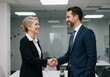 © Havoc - Business people shaking hands in a modern office with smiling faces