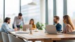© N7 - Defocused business setting capturing teamwork across in-person and virtual participants