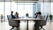 © N7 - Defocused modern office interior showing business people seated around conference table