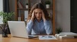 © Atelier d’Alya - Stressed Young Woman Experiencing Headache At Her Home Office Desk