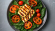 © Hina - Minimalist top view of a modern salad with warm grilled halloumi over a bed of baby spinach, cherry tomatoes, and orange baked pepper slices on a matte grey tabletop