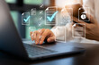 © AbdullahAl - Person working on a laptop with digital checklists and documents floating above